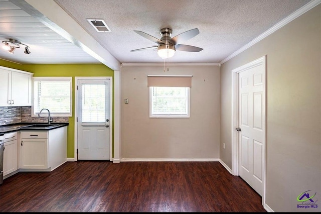 1714 Jean Ave, Albany, GA 31705 - kitchen featuring dark wood-style flooring, ceiling fan, white cabinetry, a textured ceiling, and dark countertops