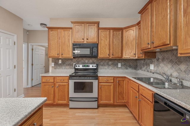 112 Finegand Pl, Warner Robins, GA 31088 - kitchen with black appliances, light countertops, light wood-style floors, and tasteful backsplash