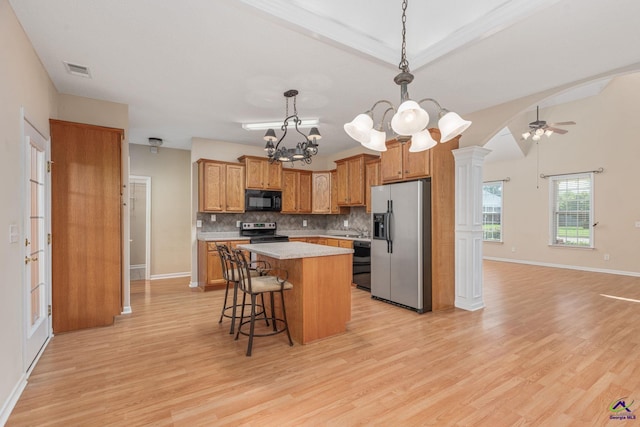 112 Finegand Pl, Warner Robins, GA 31088 - kitchen with black appliances, a chandelier, backsplash, brown cabinetry, and light countertops