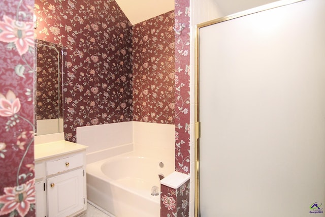 306 Bryson Way, Warner Robins, GA 31088 - full bathroom with wallpapered walls, vanity, a garden tub, and a shower with door