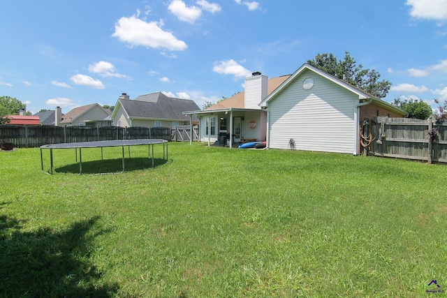 306 Bryson Way, Warner Robins, GA 31088 - back of house featuring a trampoline, a fenced backyard, and a chimney