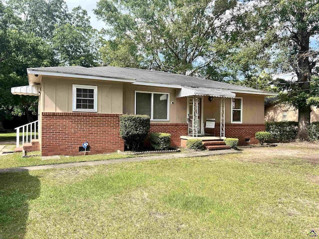 708 Princess Ave, Fort Valley, GA 31030 - bungalow with brick siding, a front yard, crawl space, and a shingled roof