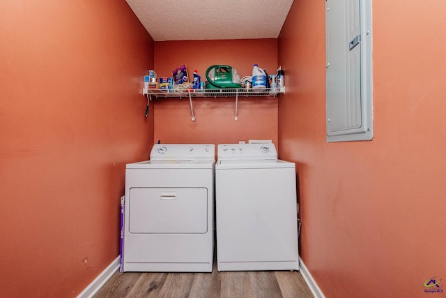 330 Hidden Creek Cir, Warner Robins, GA 31088 - laundry room featuring independent washer and dryer, electric panel, wood finished floors, and a textured ceiling