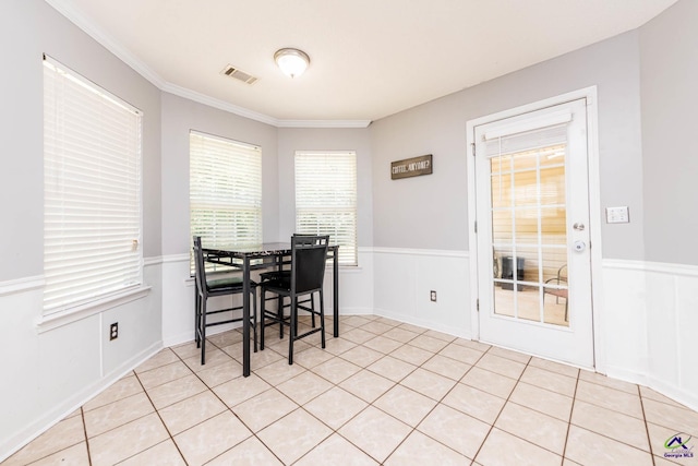 330 Hidden Creek Cir, Warner Robins, GA 31088 - dining room featuring crown molding, light tile patterned floors, and wainscoting