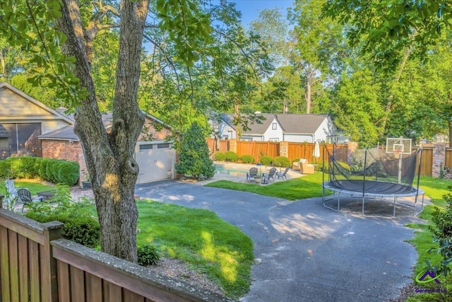 709 Evergreen St, Perry, GA 31069 - view of front of house with a trampoline, a swimming pool, a garage, and a patio area