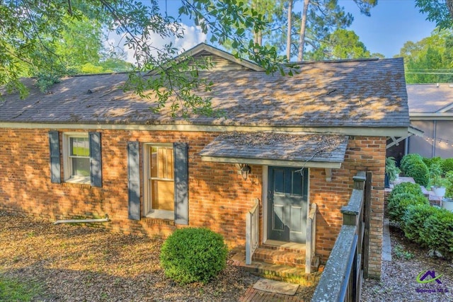 709 Evergreen St, Perry, GA 31069 - view of front facade with entry steps, a shingled roof, and brick siding