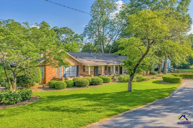 709 Evergreen St, Perry, GA 31069 - ranch-style home with a front lawn, brick siding, and covered porch