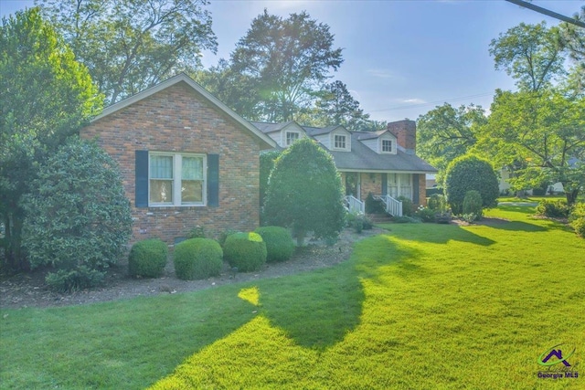 709 Evergreen St, Perry, GA 31069 - cape cod home featuring a front lawn and brick siding
