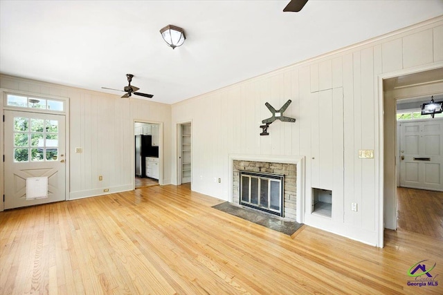 458 Pierce Ave, Macon, GA 31204 - unfurnished living room featuring a ceiling fan, wood finished floors, ornamental molding, and a stone fireplace
