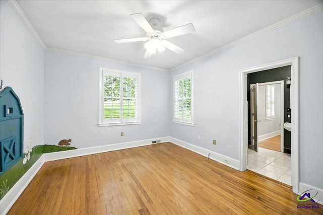 458 Pierce Ave, Macon, GA 31204 - empty room featuring light wood-type flooring, ornamental molding, and a ceiling fan