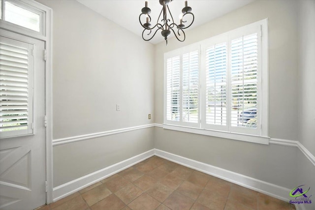 458 Pierce Ave, Macon, GA 31204 - unfurnished dining area with a chandelier, healthy amount of natural light, and tile patterned flooring