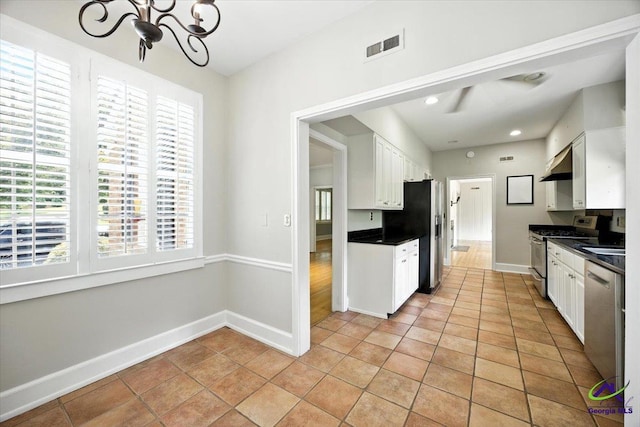 458 Pierce Ave, Macon, GA 31204 - kitchen with appliances with stainless steel finishes, a chandelier, white cabinets, plenty of natural light, and recessed lighting