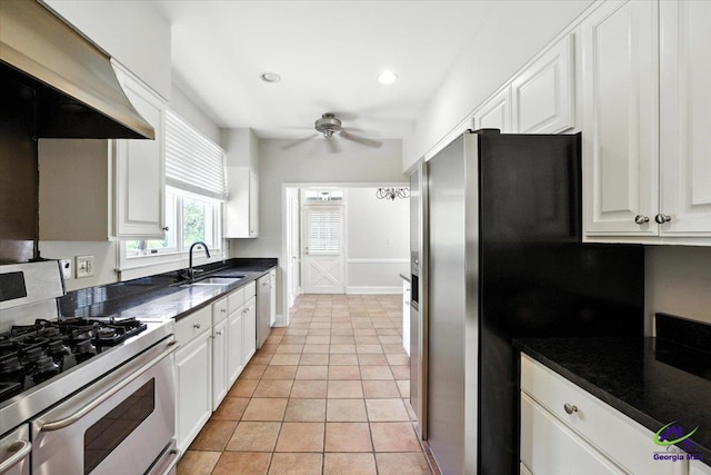 458 Pierce Ave, Macon, GA 31204 - kitchen with stainless steel appliances, a ceiling fan, white cabinetry, wall chimney exhaust hood, and recessed lighting