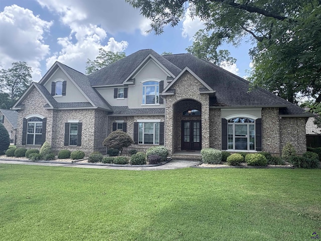 300 Stacy Ln, Warner Robins, GA 31088 - view of front of home with a front lawn, french doors, stucco siding, roof with shingles, and brick siding
