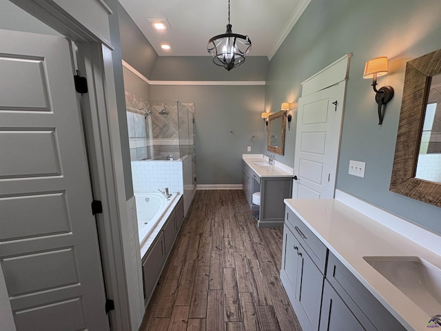 300 Stacy Ln, Warner Robins, GA 31088 - full bathroom with a stall shower, a bath, wood finished floors, two vanities, and a chandelier
