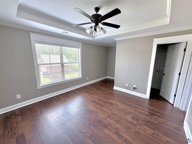 300 Stacy Ln, Warner Robins, GA 31088 - unfurnished bedroom with a tray ceiling, ornamental molding, dark wood finished floors, and a ceiling fan