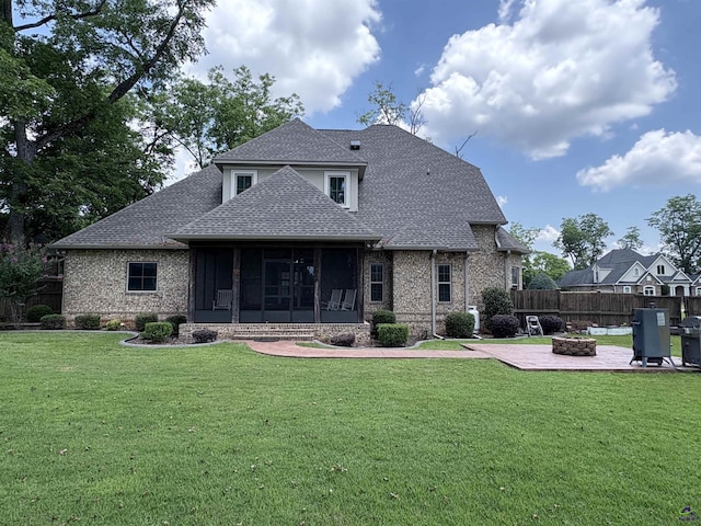 300 Stacy Ln, Warner Robins, GA 31088 - rear view of house featuring a shingled roof, a fire pit, a sunroom, brick siding, and a patio