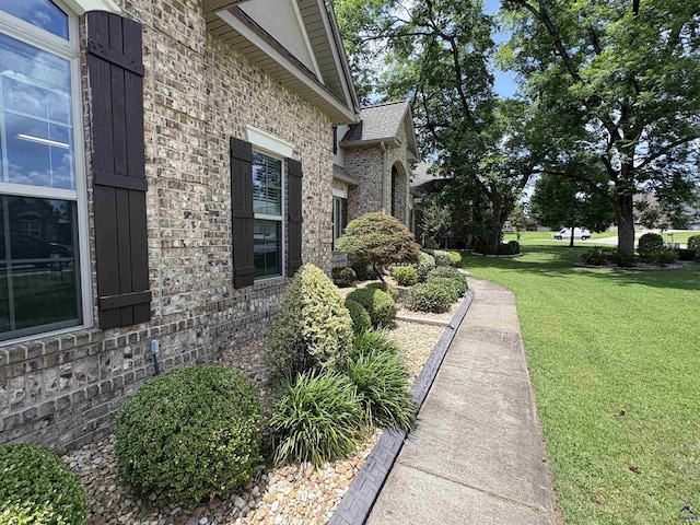 300 Stacy Ln, Warner Robins, GA 31088 - view of property exterior with brick siding and a yard