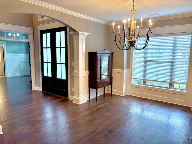 300 Stacy Ln, Warner Robins, GA 31088 - unfurnished dining area with arched walkways, a decorative wall, a chandelier, dark wood-style flooring, and ornamental molding