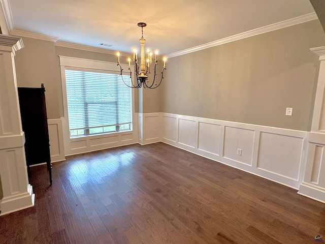 300 Stacy Ln, Warner Robins, GA 31088 - empty room with a chandelier, a decorative wall, dark wood-type flooring, a wainscoted wall, and ornamental molding