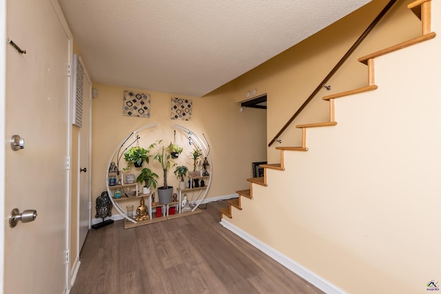 113 Stoneridge Dr, Warner Robins, GA 31088 - stairs featuring wood finished floors and a textured ceiling