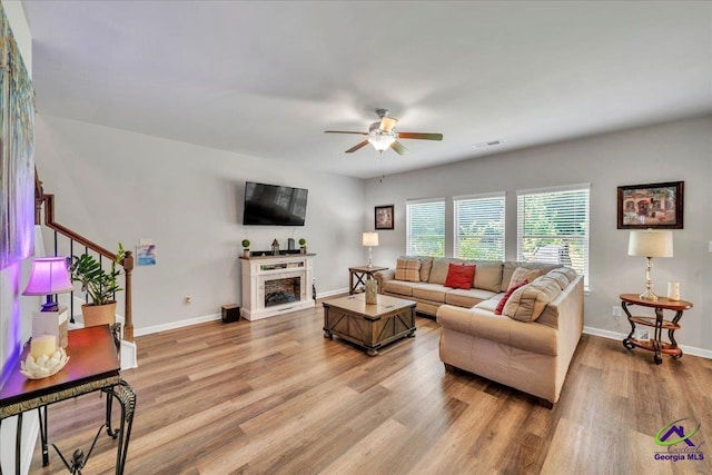 215TYNDALLWAY Tyndall Way, Perry, GA 31069 - living area with ceiling fan, light wood finished floors, a fireplace, and stairs
