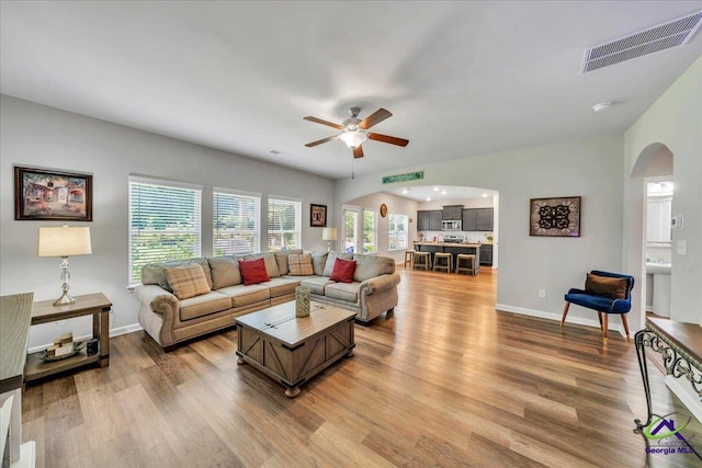 215TYNDALLWAY Tyndall Way, Perry, GA 31069 - living room with arched walkways, a ceiling fan, and wood finished floors