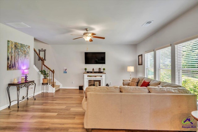 215TYNDALLWAY Tyndall Way, Perry, GA 31069 - living area with light wood-style flooring, ceiling fan, stairs, and a fireplace