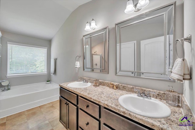 215TYNDALLWAY Tyndall Way, Perry, GA 31069 - bathroom featuring lofted ceiling, a bath, and double vanity