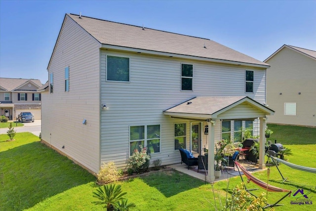 215TYNDALLWAY Tyndall Way, Perry, GA 31069 - back of property with a patio area and a lawn