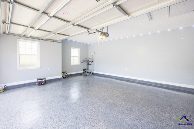129 Sugarloaf Dr, Macon, GA 31204 - garage with a garage door opener and baseboards