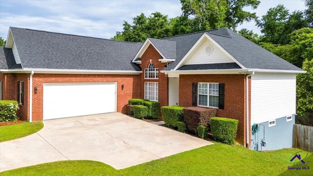 129 Sugarloaf Dr, Macon, GA 31204 - view of front of home featuring a garage, brick siding, driveway, and roof with shingles