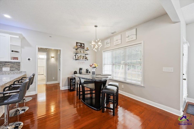 129 Sugarloaf Dr, Macon, GA 31204 - dining room with a chandelier, dark wood-style flooring, and a textured ceiling