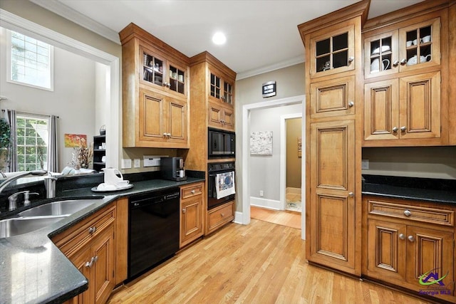 612 Remington Dr, Macon, GA 31210 - kitchen with black appliances, brown cabinetry, ornamental molding, light wood finished floors, and glass insert cabinets