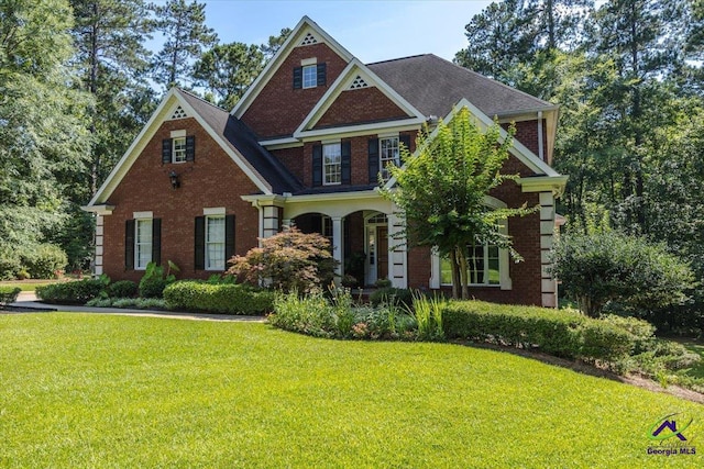 612 Remington Dr, Macon, GA 31210 - georgian-style home featuring a front yard, brick siding, and covered porch