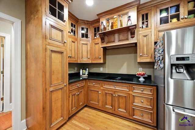 612 Remington Dr, Macon, GA 31210 - kitchen with stainless steel fridge with ice dispenser, black electric stovetop, brown cabinets, and light wood-style floors