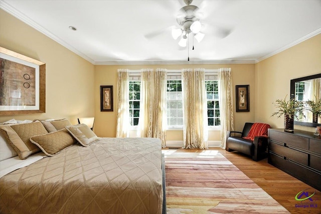612 Remington Dr, Macon, GA 31210 - bedroom featuring wood finished floors, multiple windows, ornamental molding, and a ceiling fan