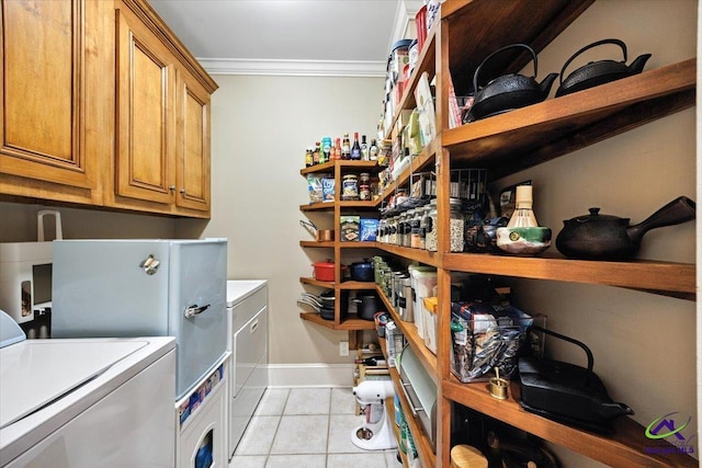 612 Remington Dr, Macon, GA 31210 - laundry area with washer / clothes dryer, crown molding, light tile patterned flooring, and cabinet space