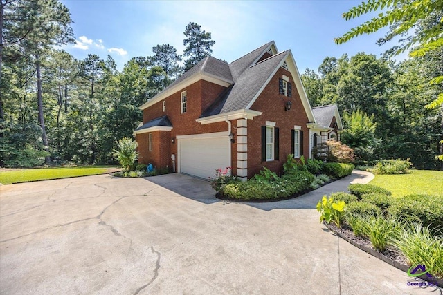 612 Remington Dr, Macon, GA 31210 - view of side of property featuring brick siding, a garage, and concrete driveway