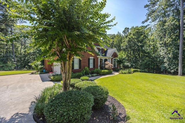 612 Remington Dr, Macon, GA 31210 - view of front of property with concrete driveway, a garage, a front lawn, and brick siding