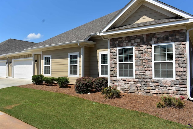 116 Sasanqua Dr, Warner Robins, GA 31088 - craftsman house with stone siding, an attached garage, roof with shingles, and driveway