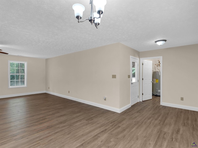 434 Barnes Rd, Jackson, GA 30233 - unfurnished living room with water heater, wood finished floors, a chandelier, and a textured ceiling