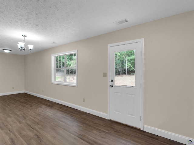434 Barnes Rd, Jackson, GA 30233 - foyer featuring a chandelier, dark wood-style flooring, and a textured ceiling