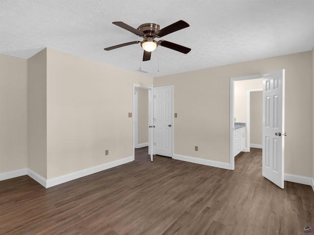 434 Barnes Rd, Jackson, GA 30233 - unfurnished bedroom featuring dark wood-type flooring, a textured ceiling, and ceiling fan