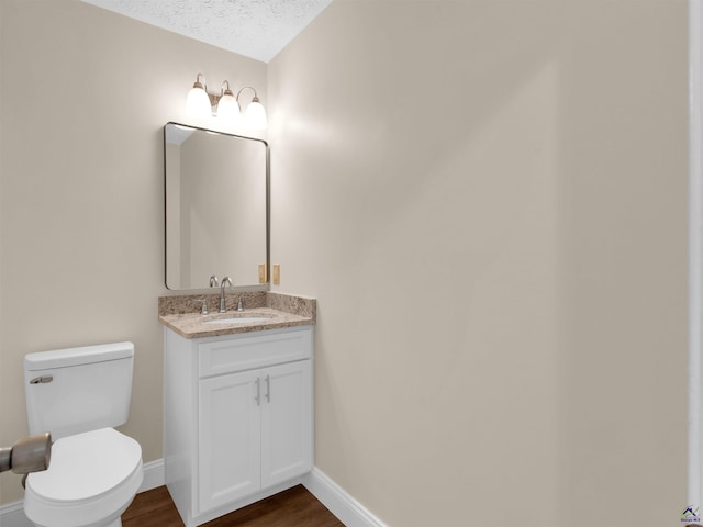 434 Barnes Rd, Jackson, GA 30233 - half bath featuring vanity, wood finished floors, and a textured ceiling