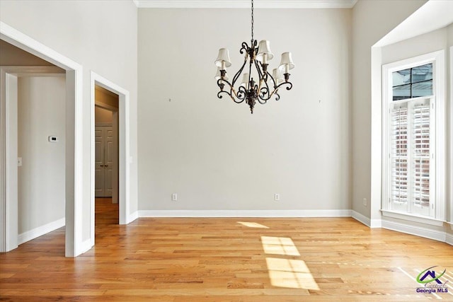 208 W Troon, Macon, GA 31210 - unfurnished dining area with a chandelier, light wood finished floors, and ornamental molding