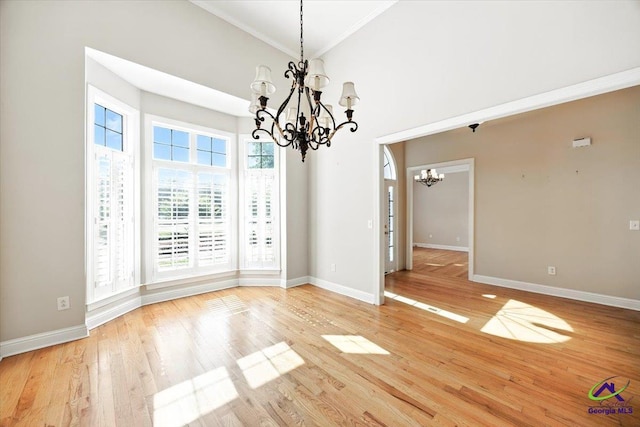 208 W Troon, Macon, GA 31210 - unfurnished dining area with a chandelier, light wood-type flooring, crown molding, and a high ceiling