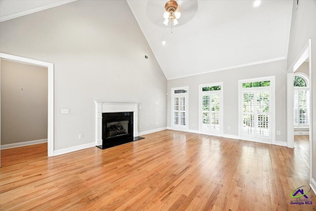 208 W Troon, Macon, GA 31210 - unfurnished living room with high vaulted ceiling, ceiling fan, a glass covered fireplace, and light wood-style flooring