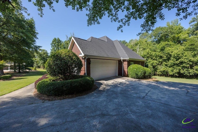 208 W Troon, Macon, GA 31210 - view of property exterior with brick siding, driveway, a garage, and a lawn