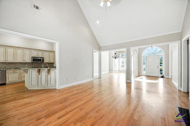 208 W Troon, Macon, GA 31210 - unfurnished living room with high vaulted ceiling, a chandelier, light wood-style flooring, and a ceiling fan